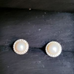 Cream pink pearl earrings surrounded by diamonds